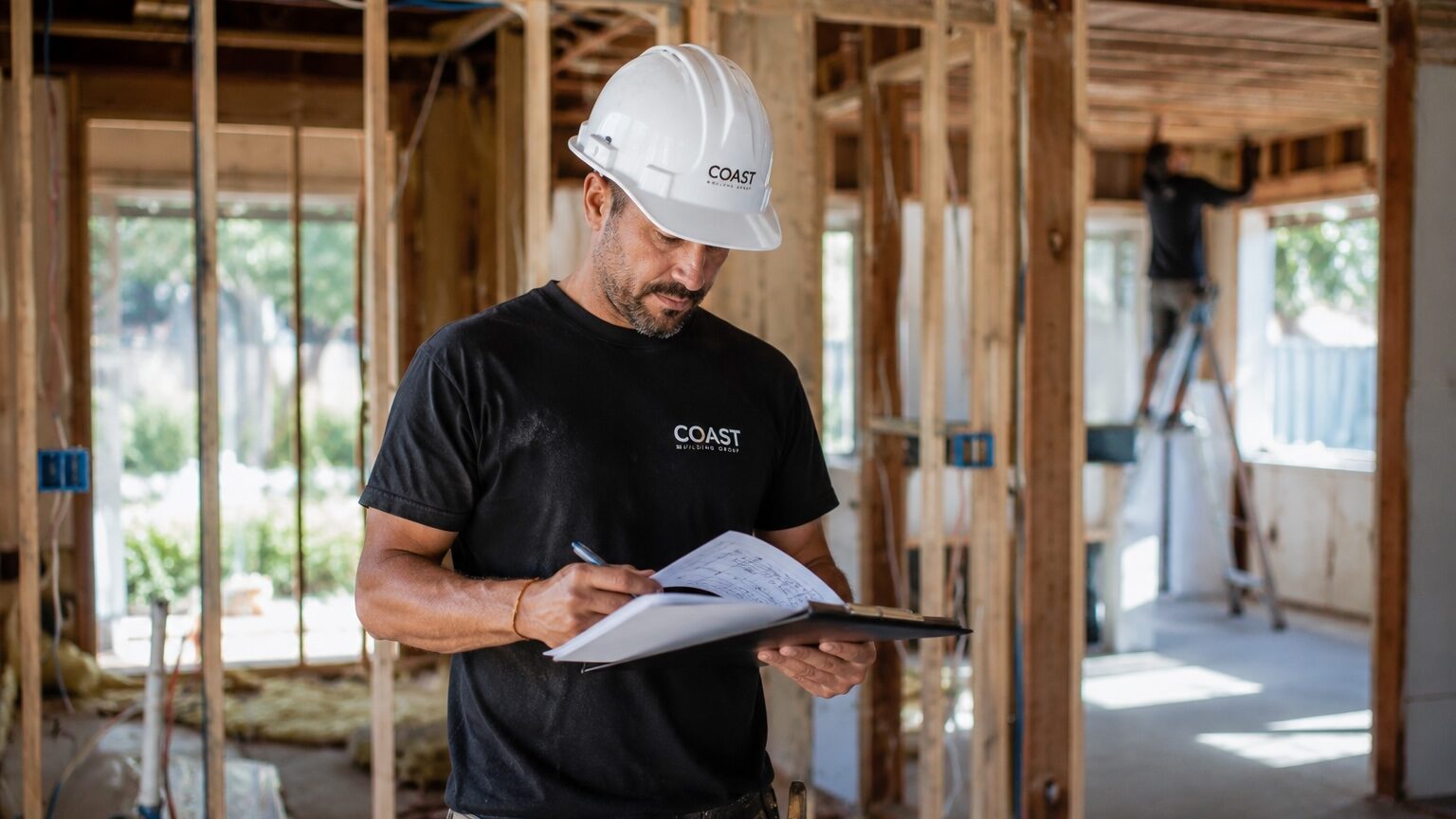 General contractor reviewing remodeling plans at an active Santa Barbara construction site