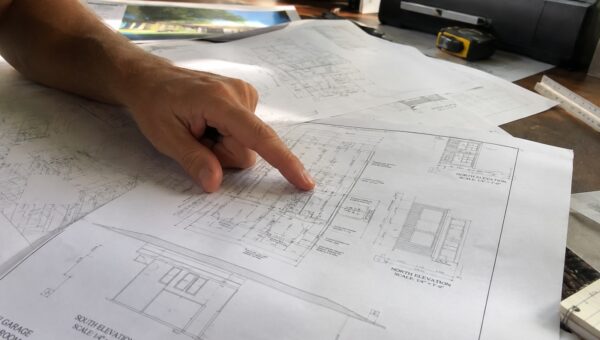 Homeowner and drafter reviewing a feasibility study Santa Barbara property assessment